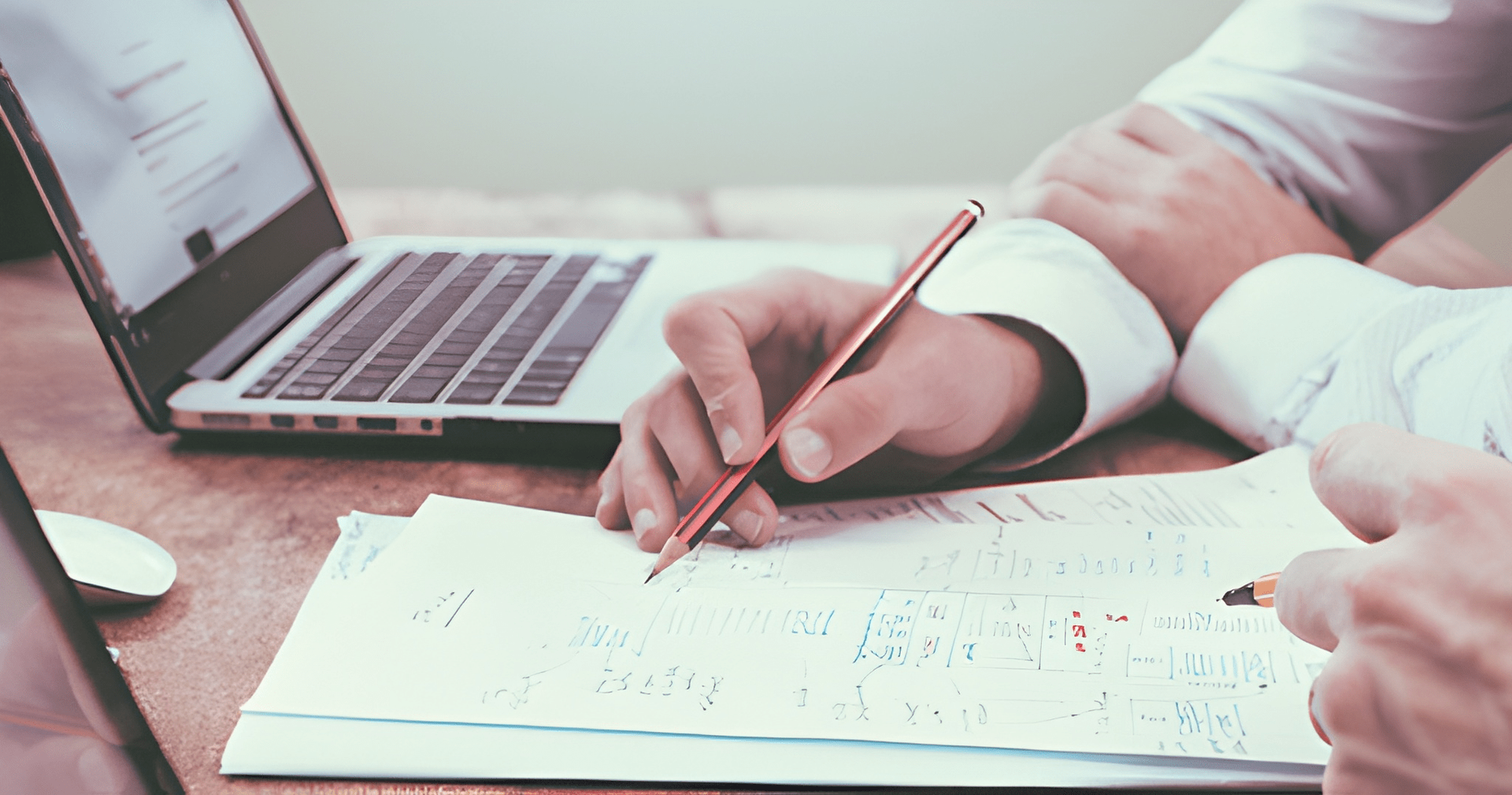 Hands Writing on a Document With a Laptop in the Background — Midcoast Financial Planning Group in Tuncurry, NSW