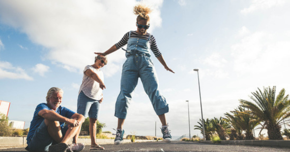 Three People Outdoors; One Jumps With Arms Out — Midcoast Financial Planning Group in Tuncurry, NSW
