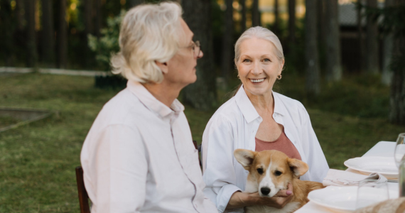 Two People and A Dog Seated — Midcoast Financial Planning Group in Tuncurry, NSW