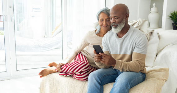 Older Adult Couple on A Sofa — Midcoast Financial Planning Group in Tuncurry, NSW