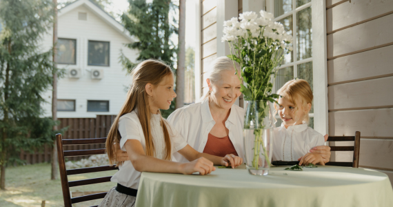 Woman And Two Children At A Table — Midcoast Financial Planning Group in Tuncurry, NSW