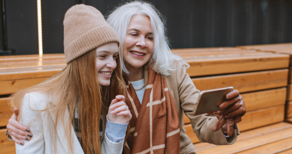 Woman With Gray Hair Hugs Younger Woman — Midcoast Financial Planning Group in Tuncurry, NSW