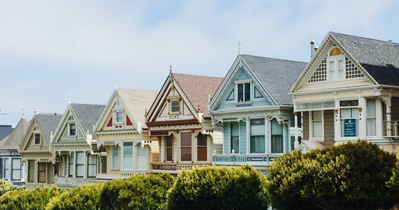 Row of colorful Victorian houses with manicured hedges — Midcoast Financial Planning Group in Tuncurry, NSW