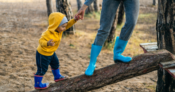 Child In Yellow Hoodie And Blue Boots — Midcoast Financial Planning Group in Tuncurry, NSW