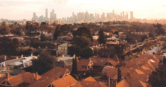 Houses and Trees in Foreground, Cityscape with Skyscrapers — Midcoast Financial Planning Group in Tuncurry, NSW