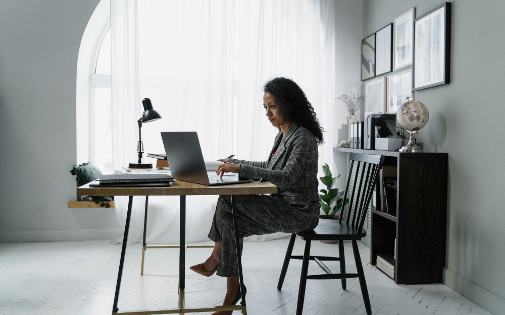 Woman in Suit Working on A Laptop — Midcoast Financial Planning Group in Tuncurry, NSW