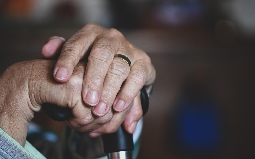 An Elderly Person's Hands One With a Ring