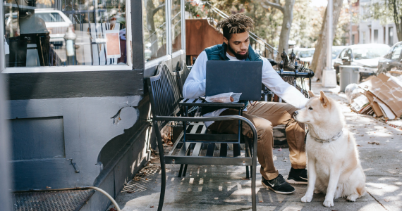 Man Working On Laptop, Sitting On Bench — Midcoast Financial Planning Group in Tuncurry, NSW