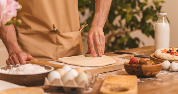 Person Making Pizza, Cutting Dough — Midcoast Financial Planning Group in Tuncurry, NSW