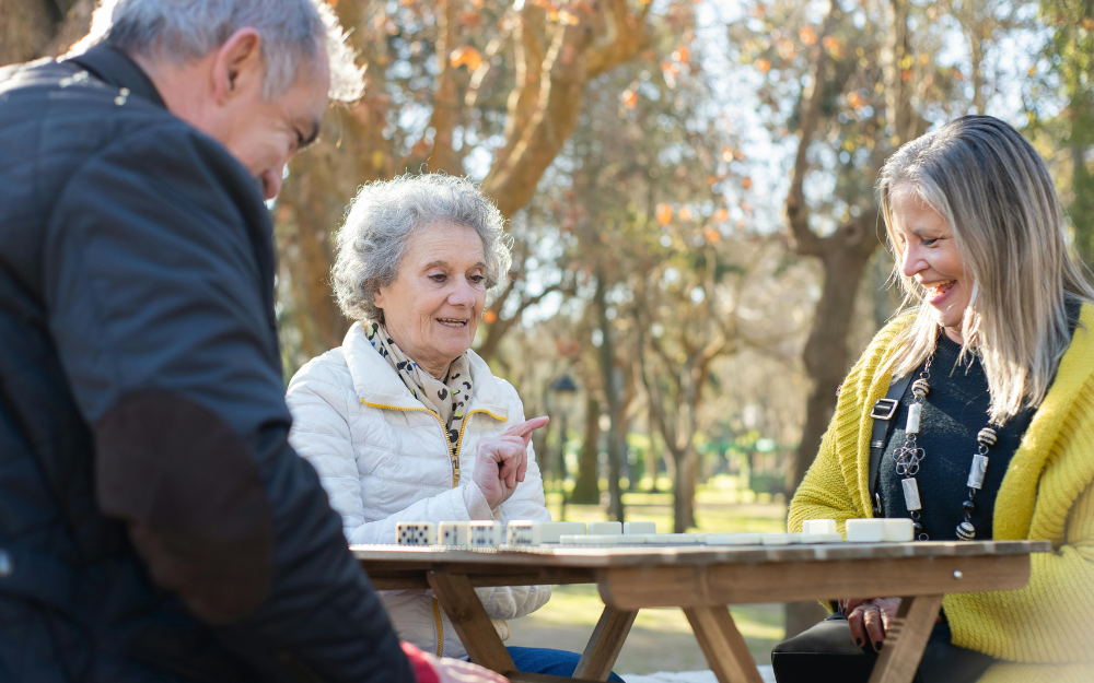 Three Older Adults Play a Game Outdoors — Midcoast Financial Planning Group in Tuncurry, NSW