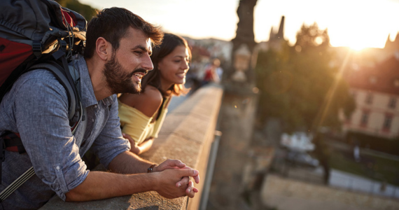 Couple With Backpacks Overlooking A City — Midcoast Financial Planning Group in Tuncurry, NSW