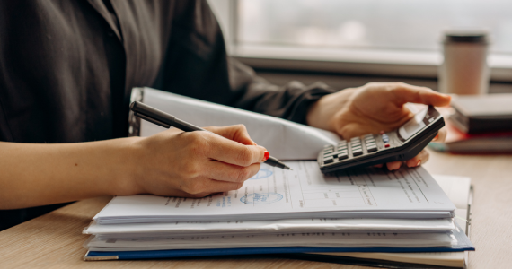 Person Calculating With A Calculator  — Midcoast Financial Planning Group in Tuncurry, NSW