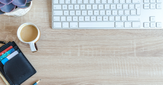 Desk with Keyboard, Coffee, Wallet with Cards, and Succulent Plant — Midcoast Financial Planning Group in Tuncurry, NSW