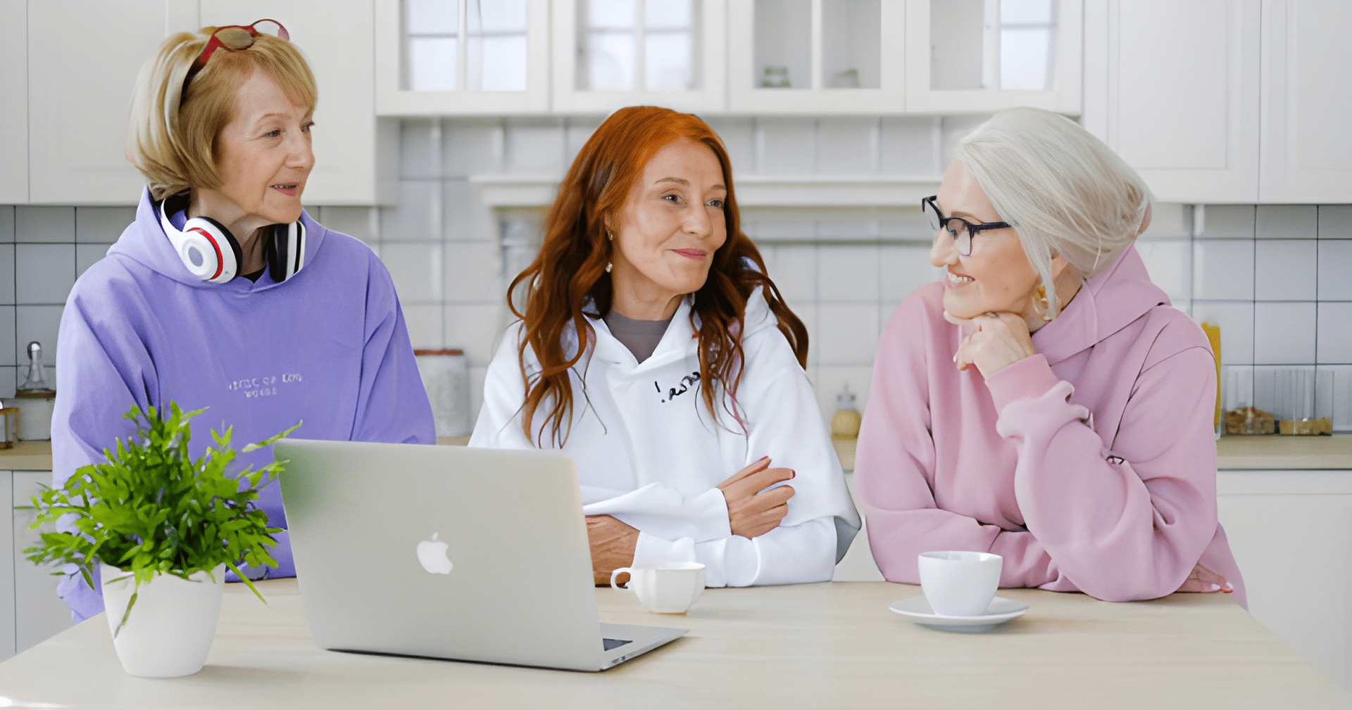 Three Women in Sweaters Around a Laptop — Midcoast Financial Planning Group in Tuncurry, NSW