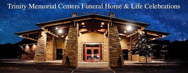 The trinity memorial centers funeral home and life celebrations building is lit up at night