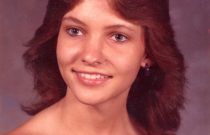 A close up of a woman 's face with a smile on her face.