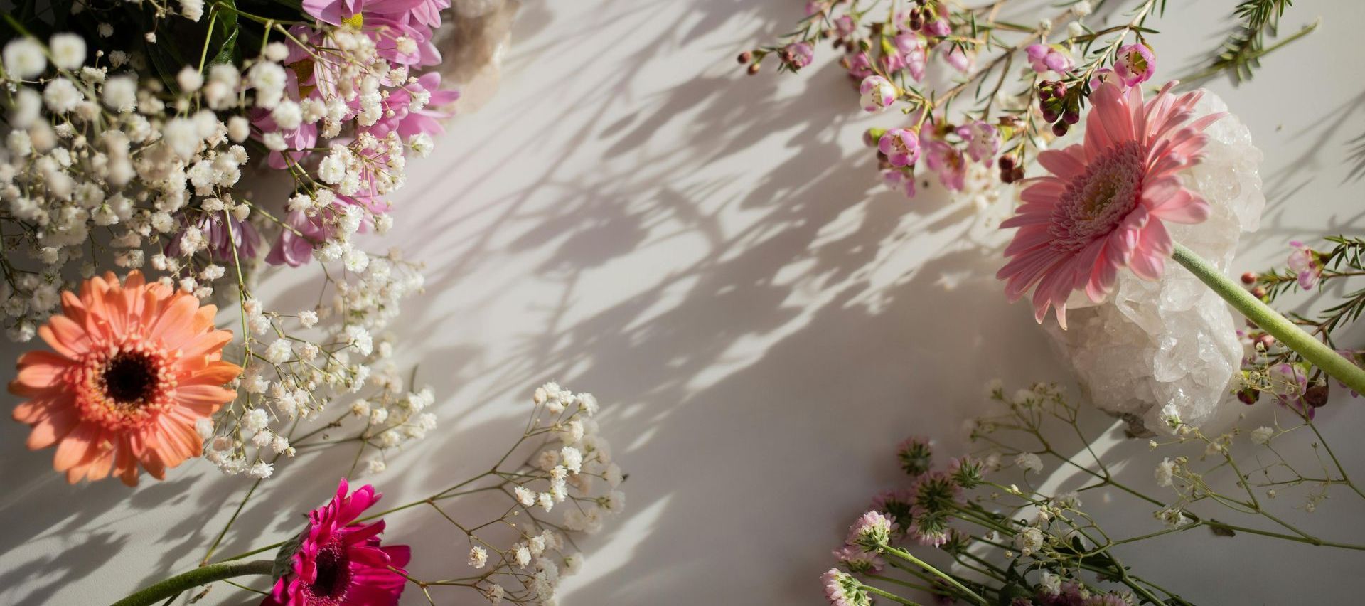 There are many different types of flowers on the table.