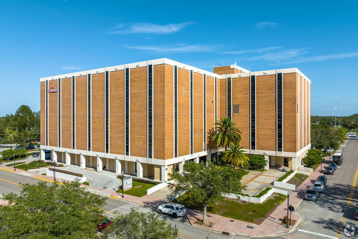 Workplace with stations along the wall and glass door at the end