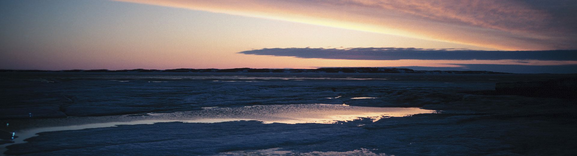 A blurry picture of a sunset over a body of water.