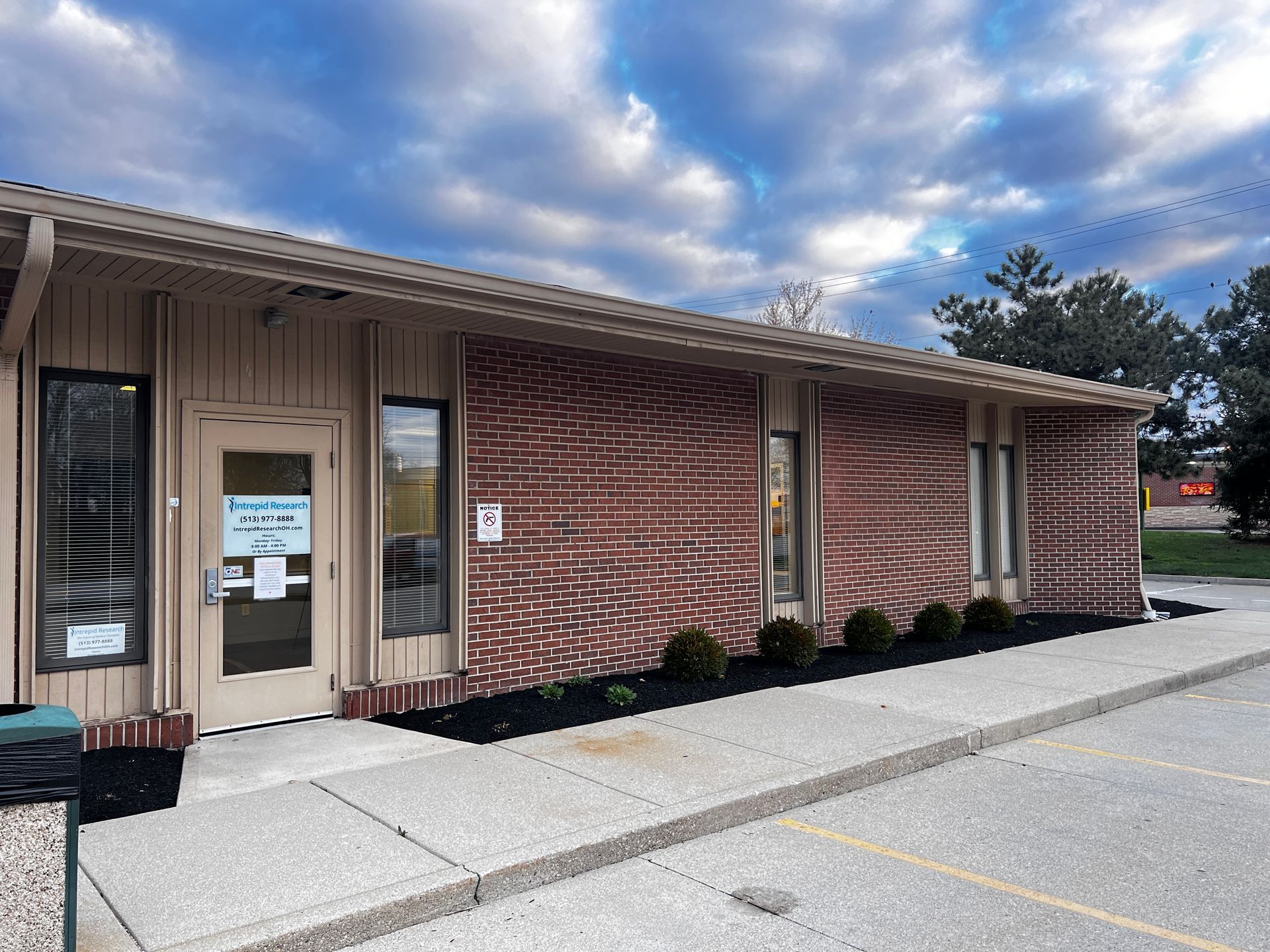 A brick building with a sign on the door that says ' dental office ' | Intrepid Research