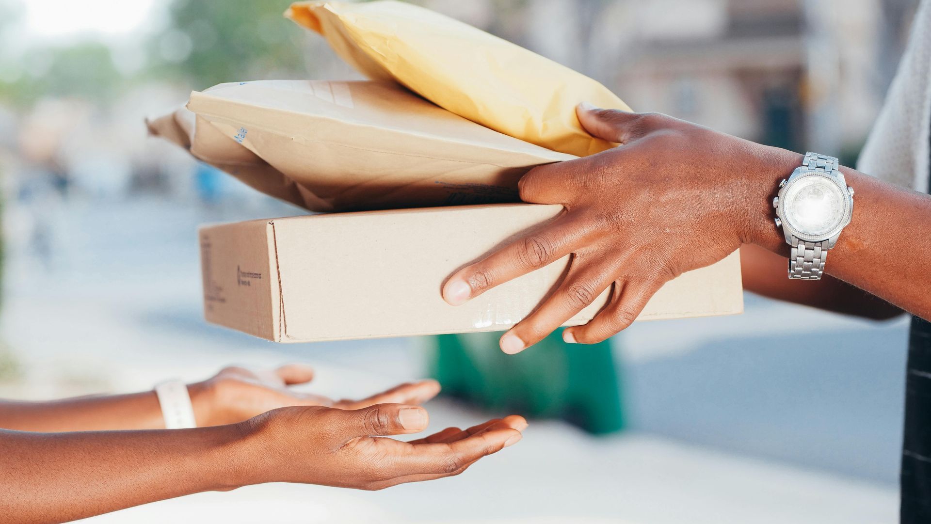 A man is handing a package to a woman.