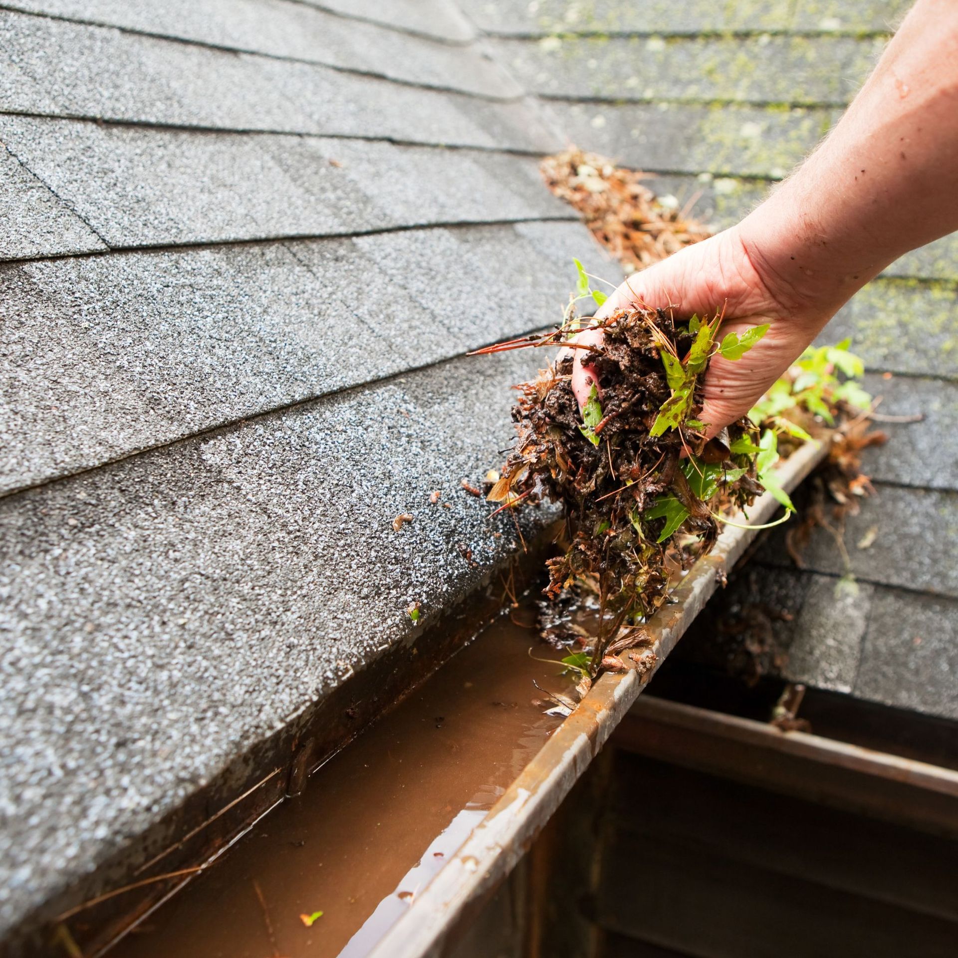A before and after picture of a gutter on a roof