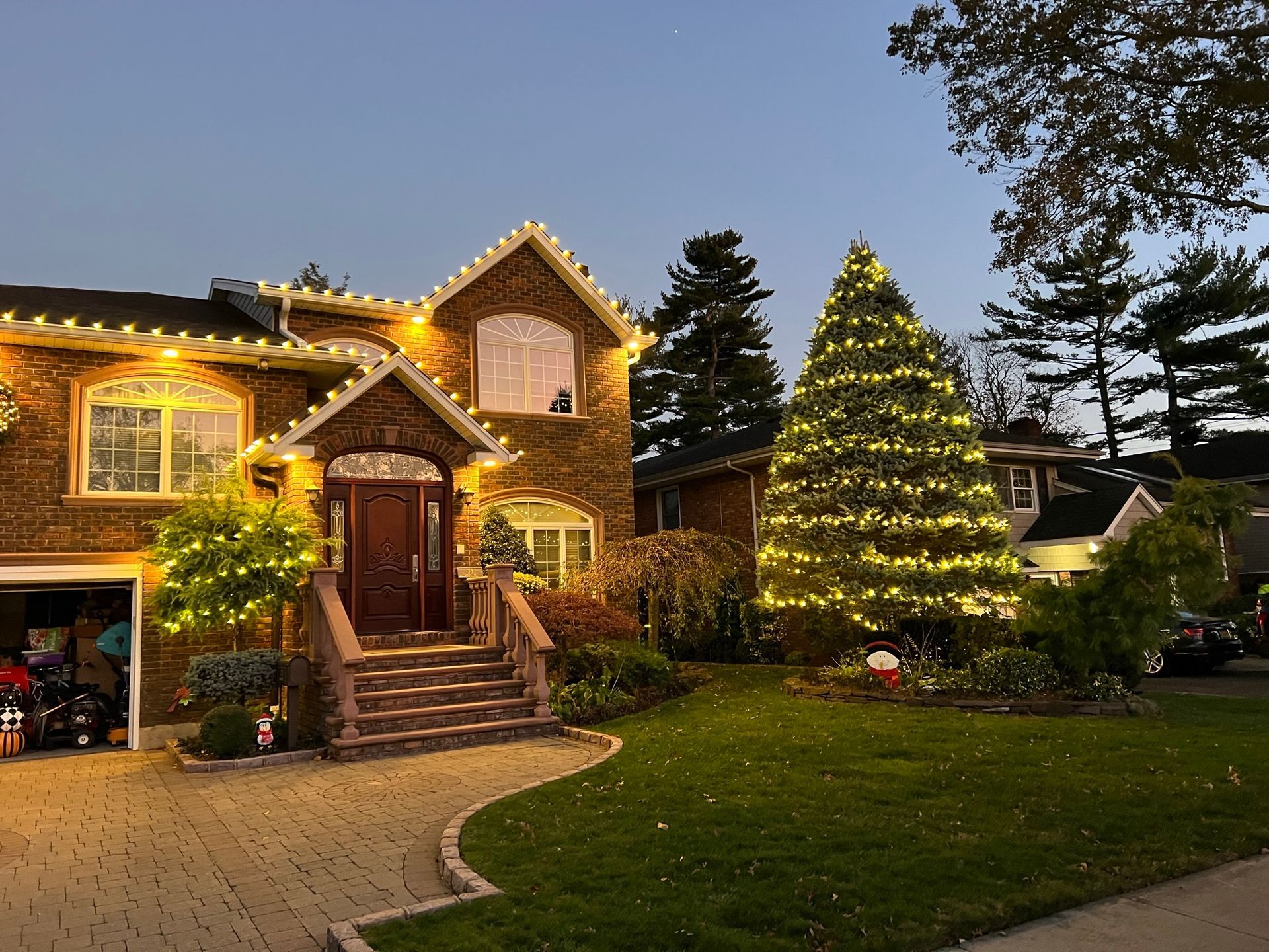 A large stone house with holiday lights