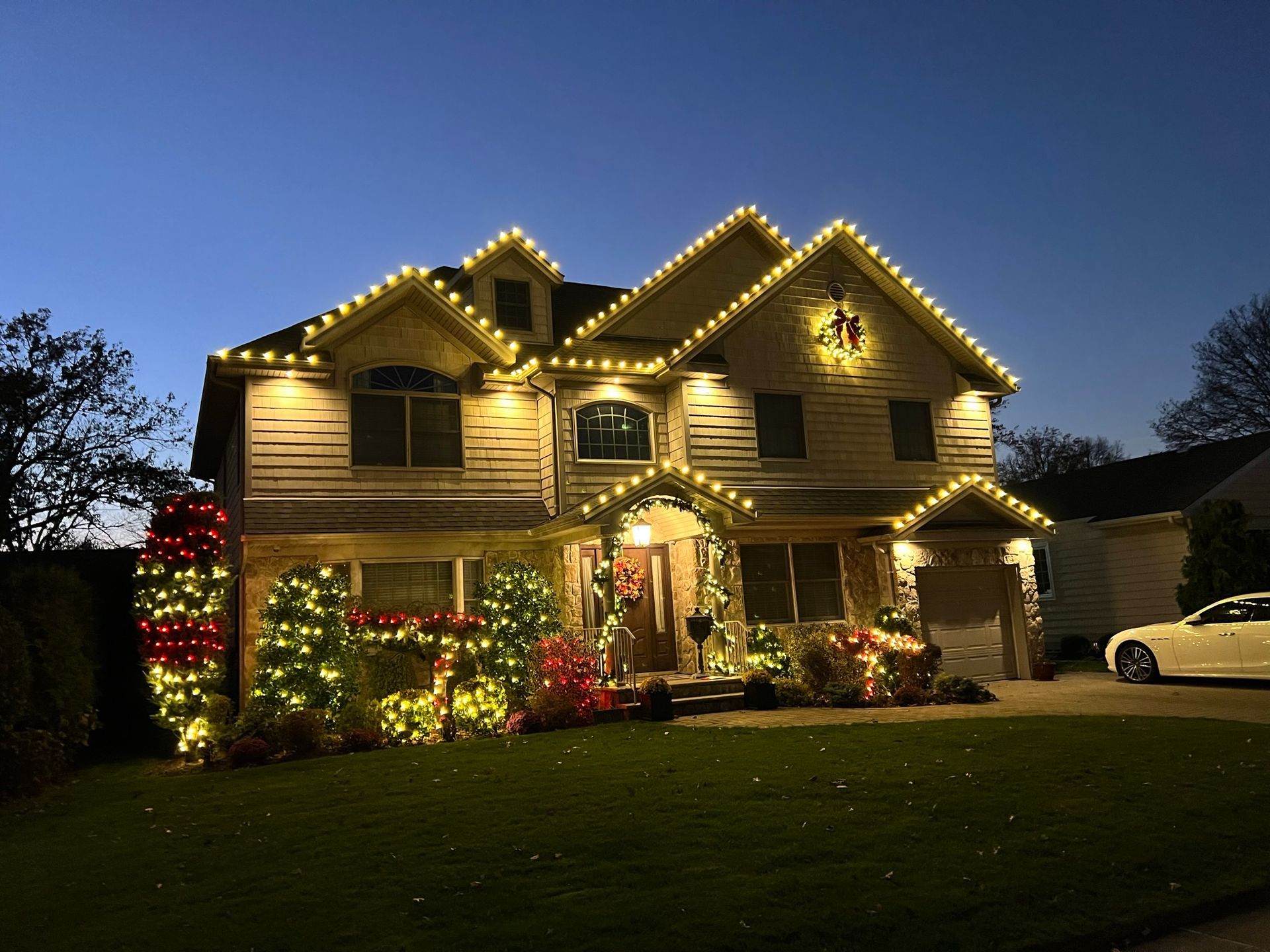 A man is using a pressure washer to clean the side of a house