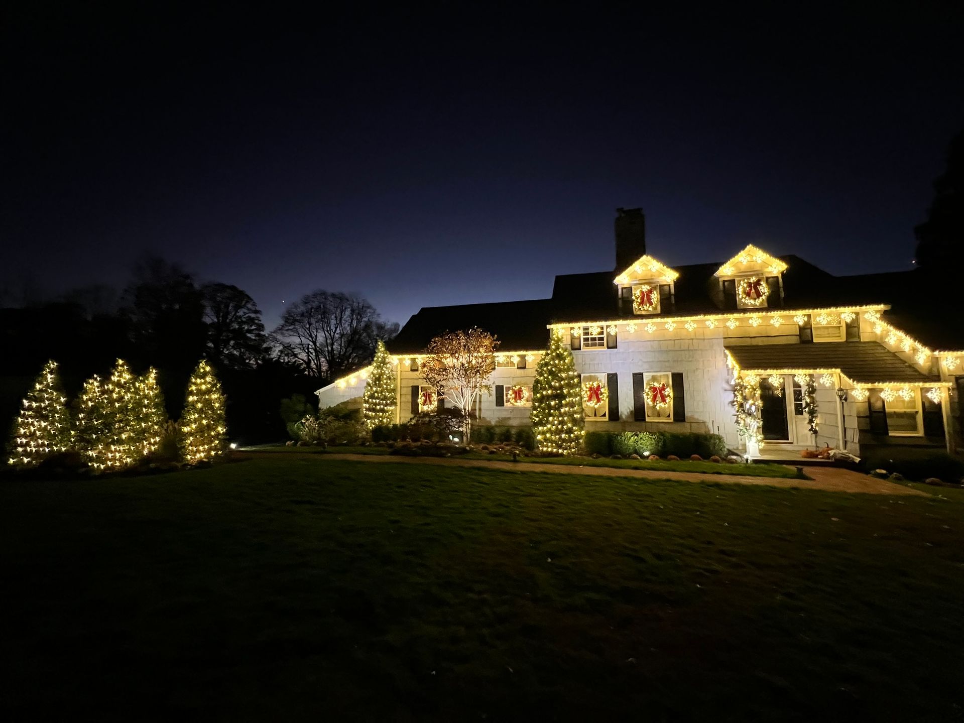 House decorated with red holiday string lights
