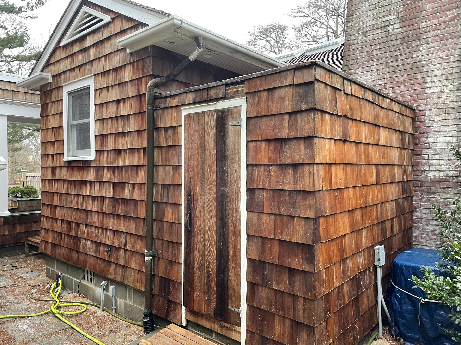 A small wooden shed after pressure washing