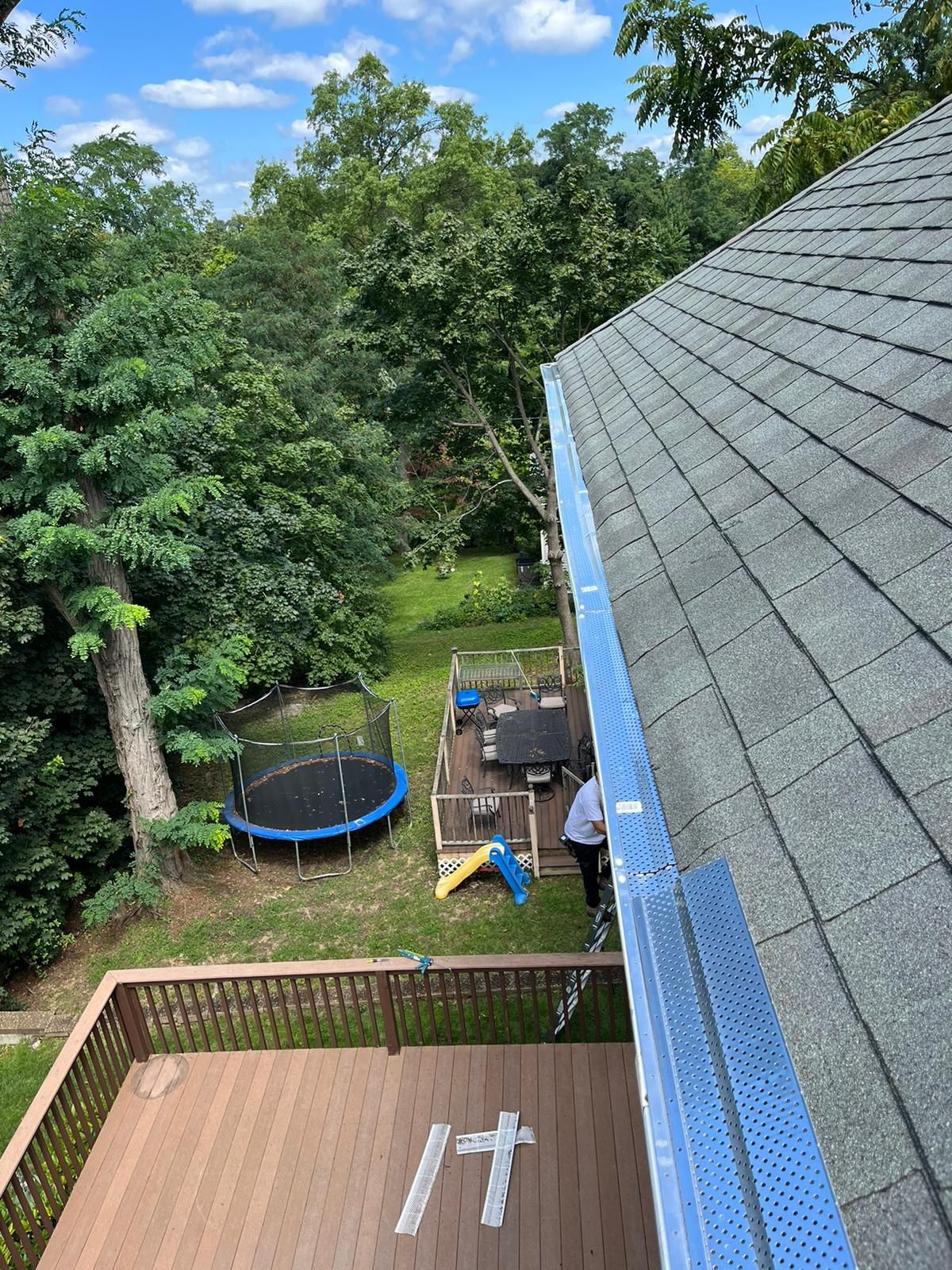 Top view of newly installed gutter guards on roof edge