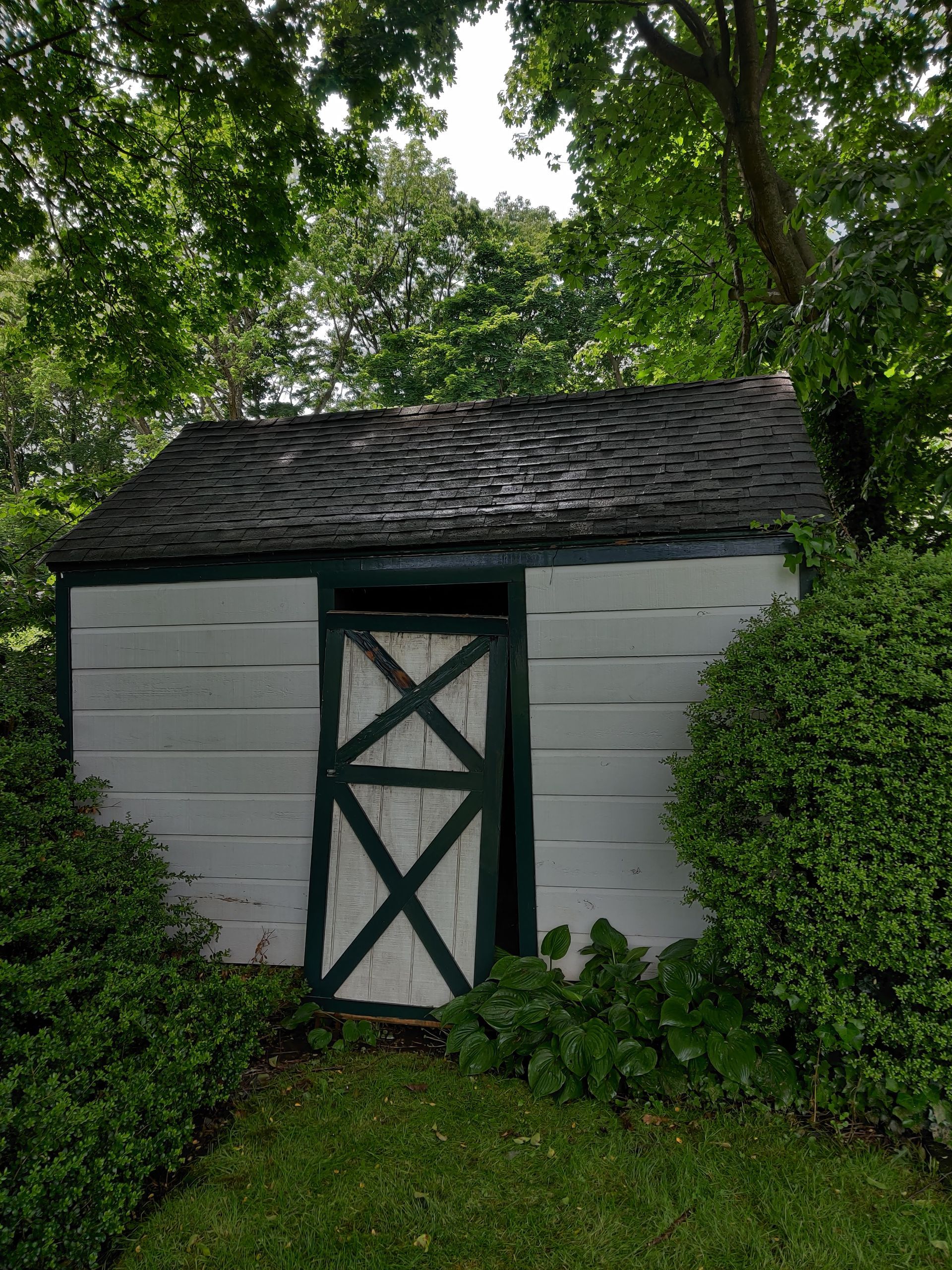 A white shed after pressure washing