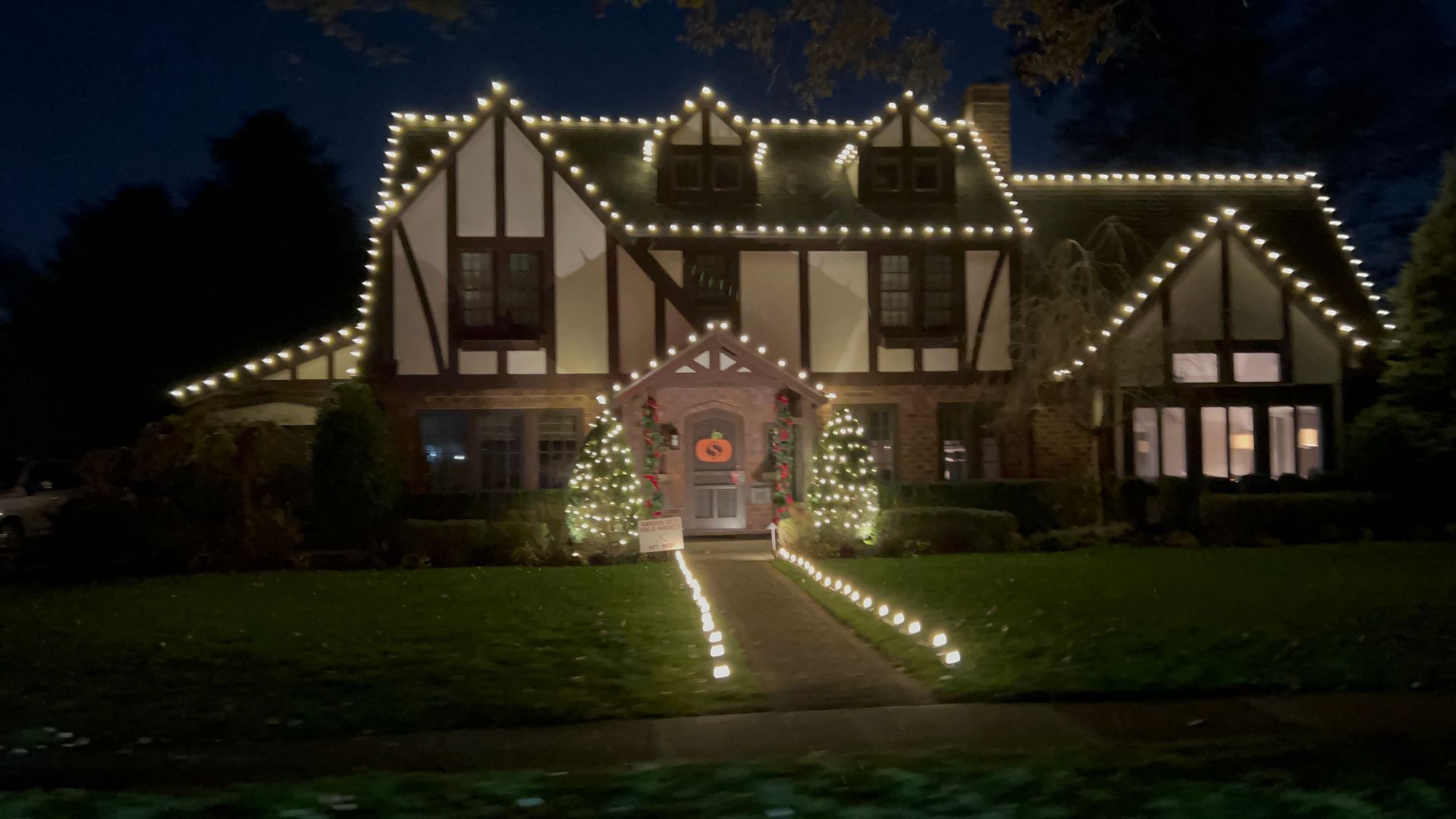 Night view of home glowing with holiday decorations
