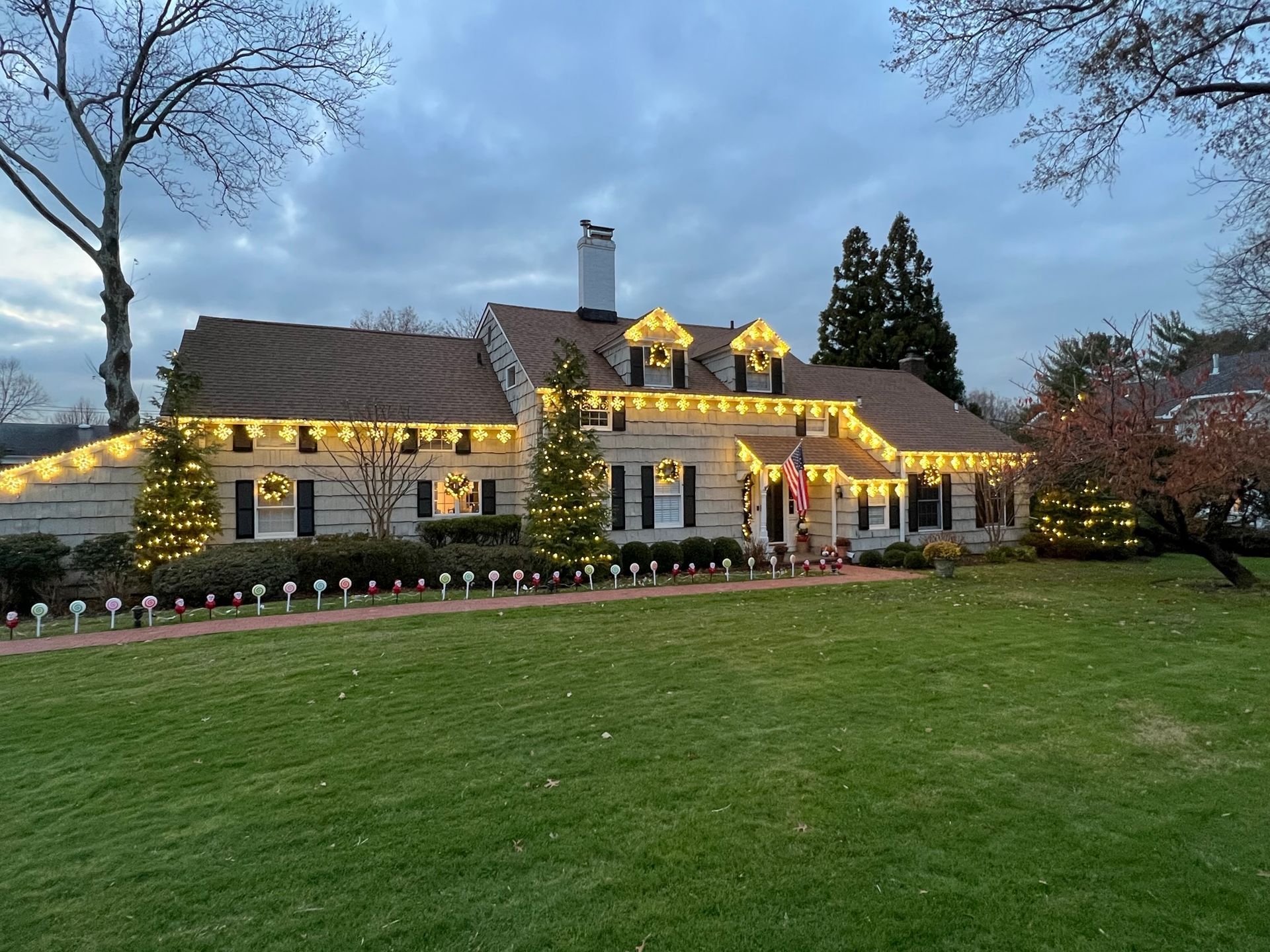 Front porch and roofline shining with festive lights
