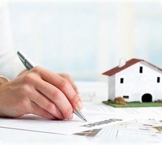 Hand signing real estate contract - Property Attorney in Onondaga County, NY