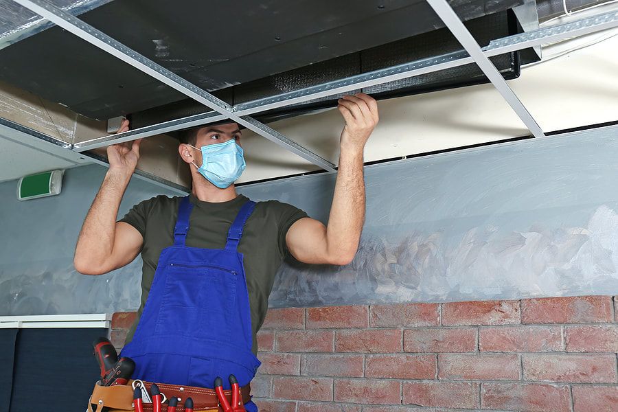 a technician performing an air vent cleaning in arizona