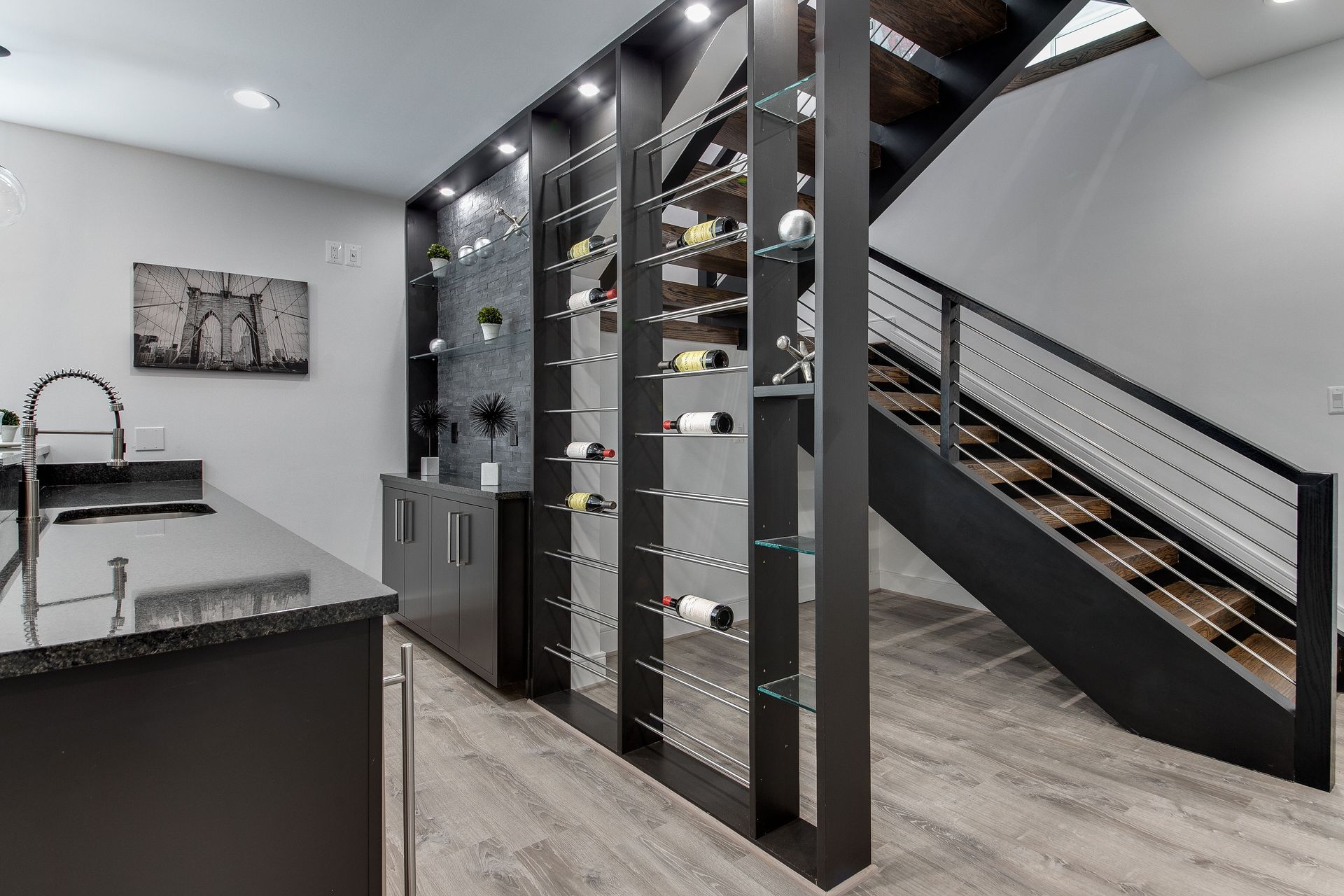 Spacious kitchen with island, sink, and pendant lights. A fireplace is visible in the background.