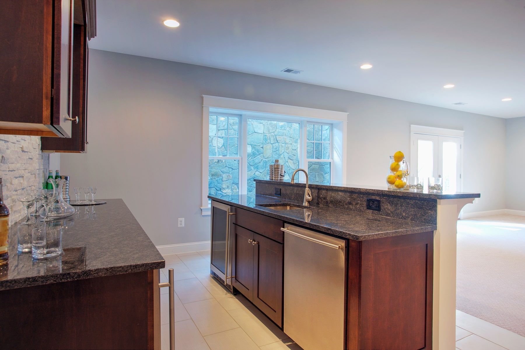 Kitchen with dark brown cabinets, granite countertops, and stainless steel appliances.