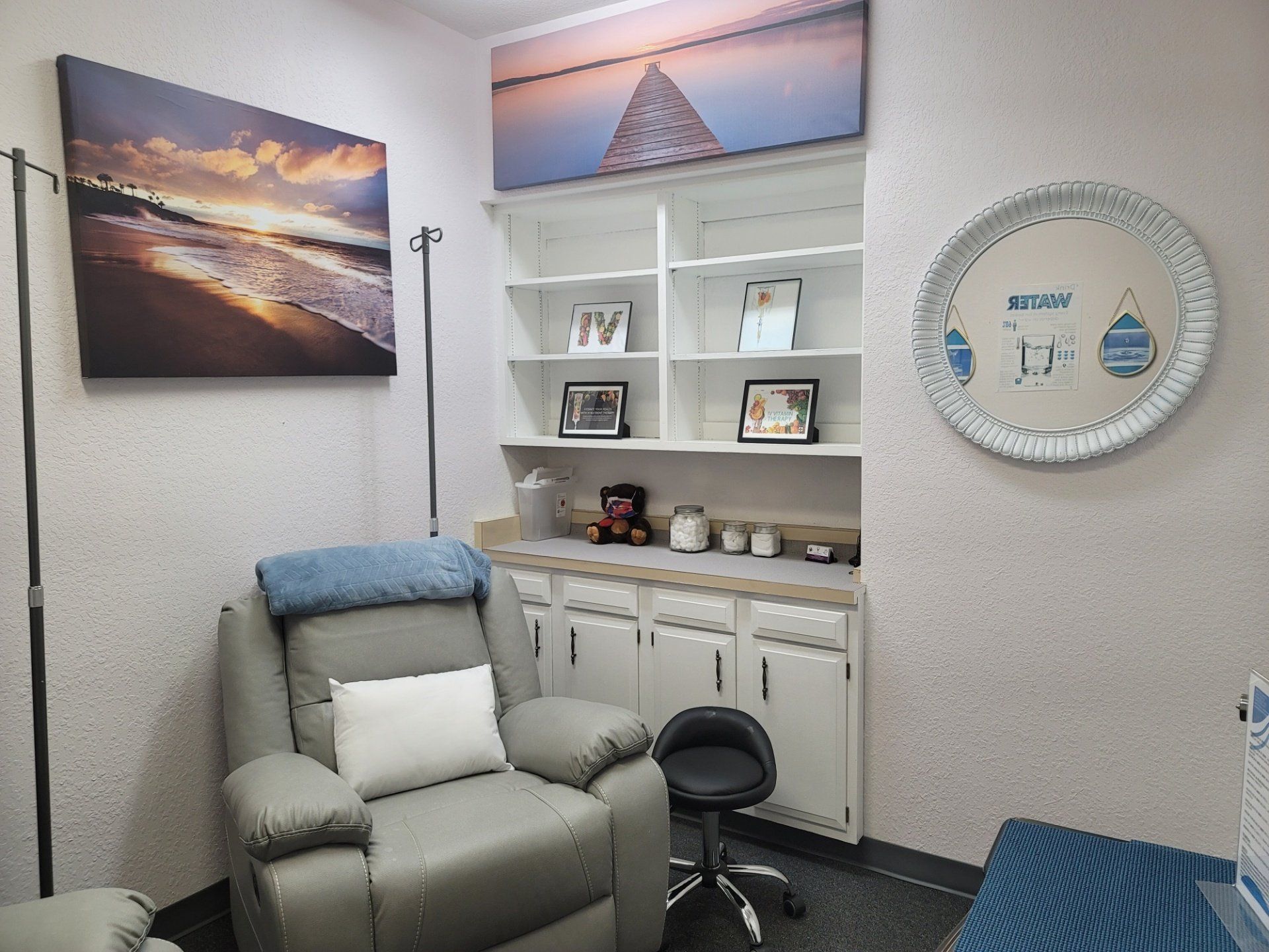 A room with a recliner and a mirror on the wall.