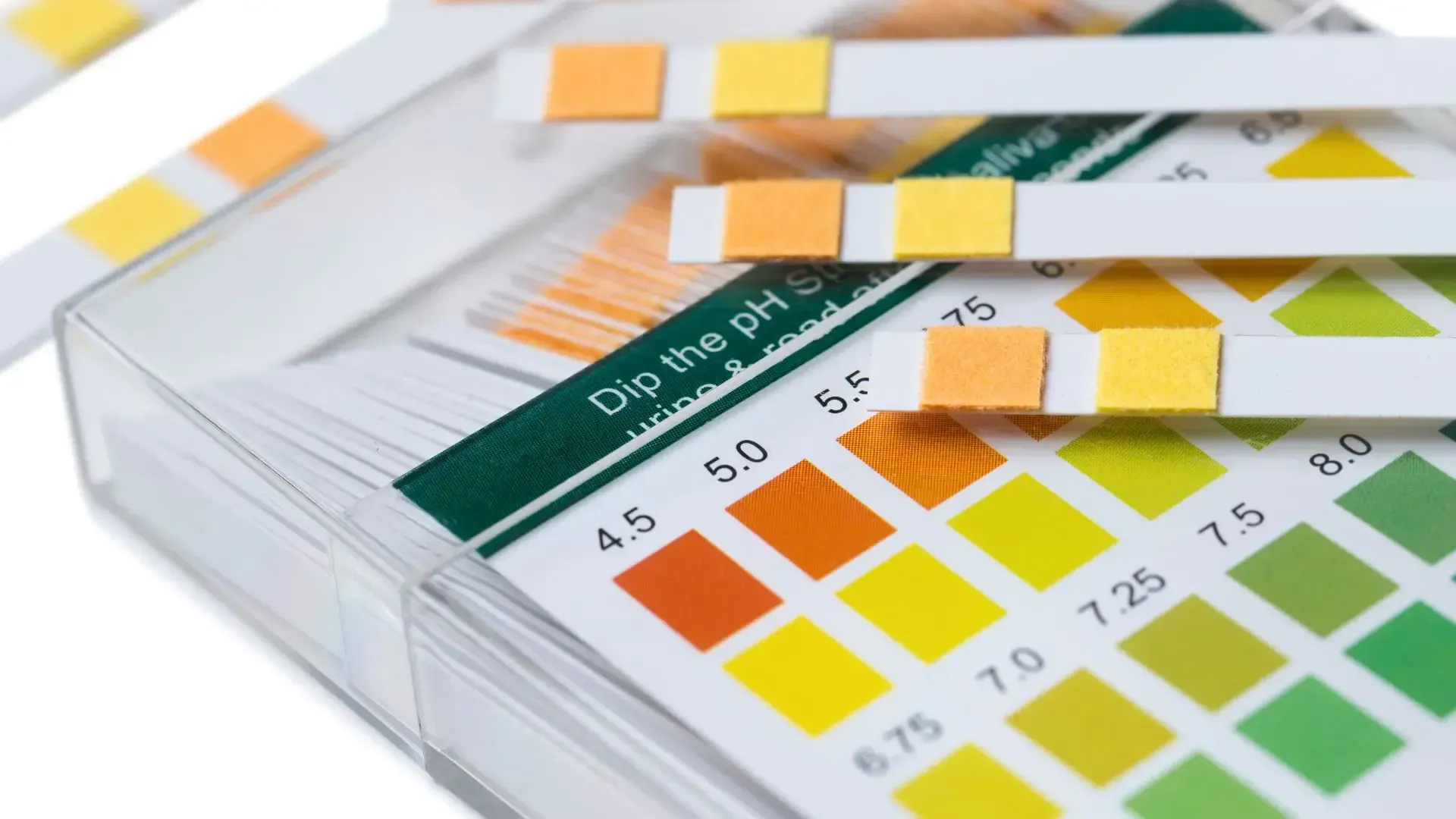 A box of ph test strips that are stacked on top of each other