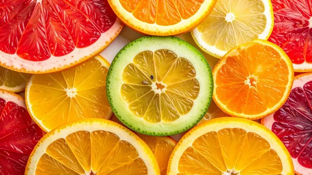 Slices of citrus fruits: grapefruit, oranges, lemons, and a lime.