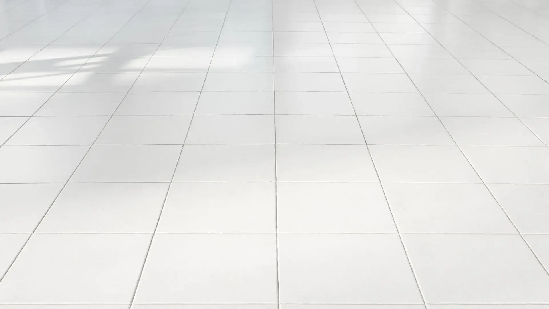White tiled floor with sunlight shadows.