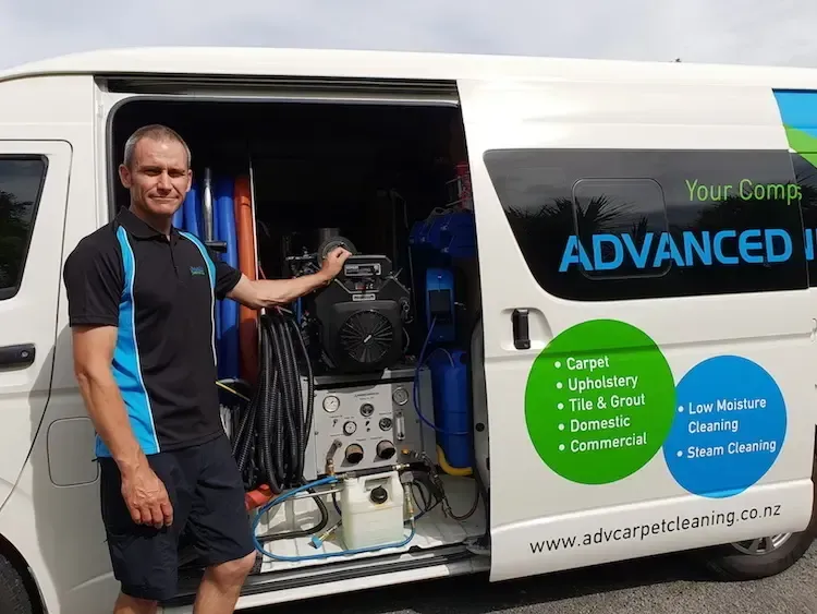 A man is standing in front of an advanced cleaning van.