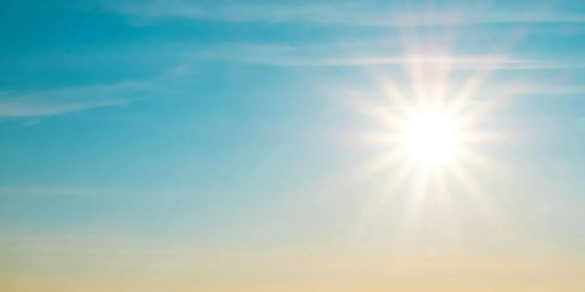 Bright sun in a blue and yellow sky.