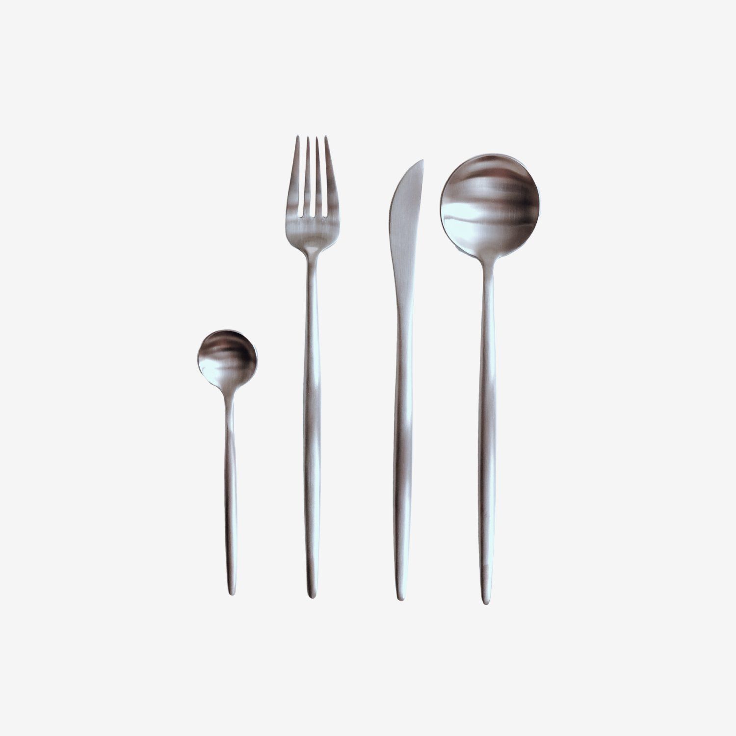 Four silver utensils arranged on a white background: spoon, fork, knife, and ladle.