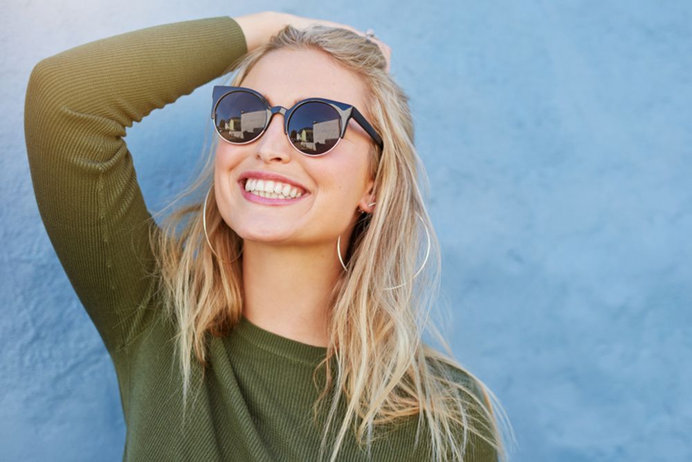Woman Wearing Sunglass While Looking Up — Central Coast Eyecare In Gosford, NSW