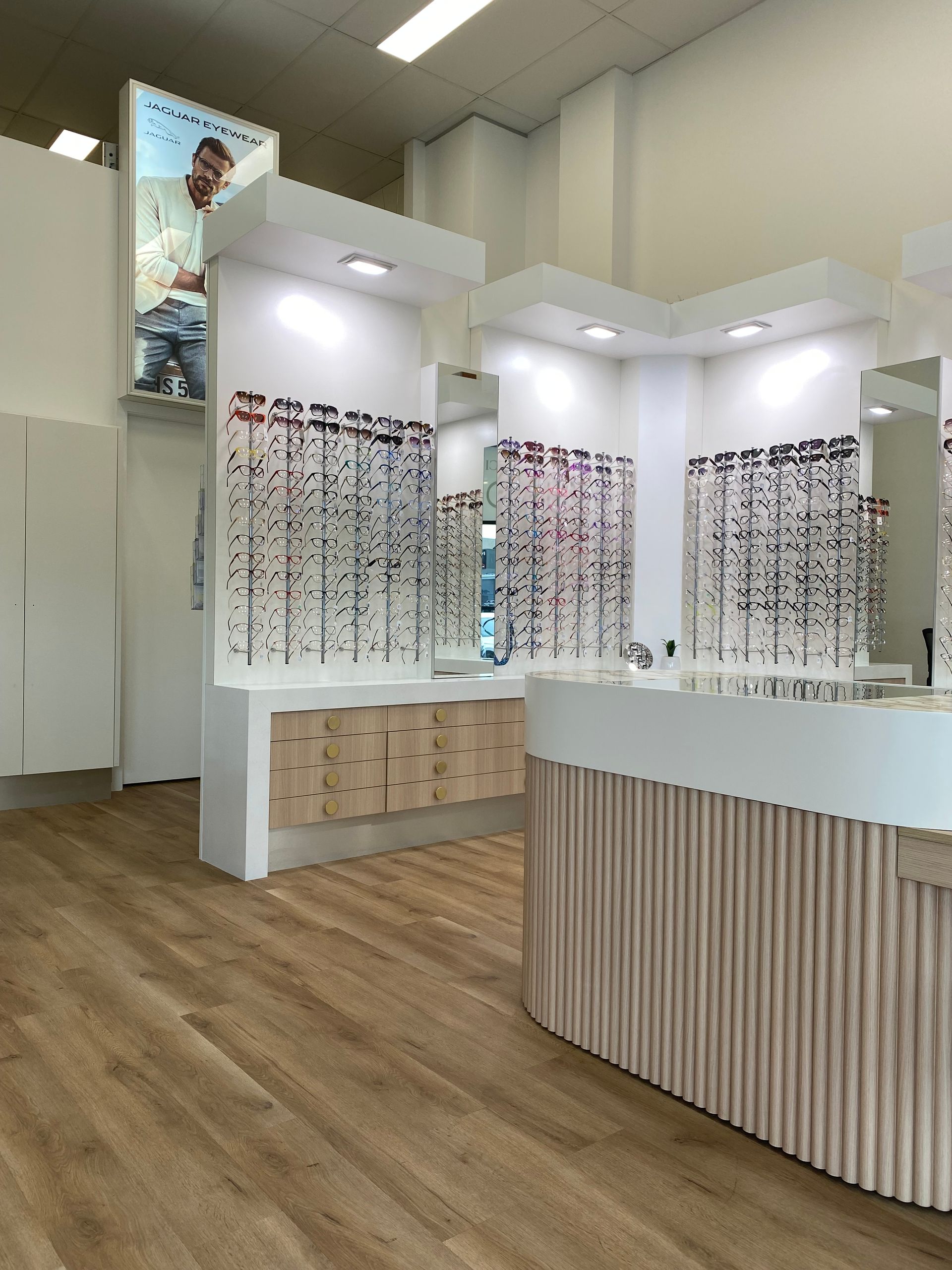 An Ophthalmologist Is Pointing At A Woman 's Eye Chart — Central Coast Eyecare In Erina, NSW