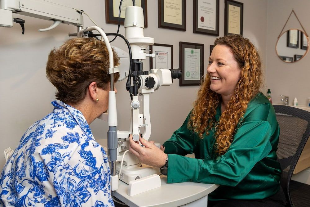 A Woman Is Getting Her Eyes Examined By An Ophthalmologist — Central Coast Eyecare In Killarney Vale, NSW
