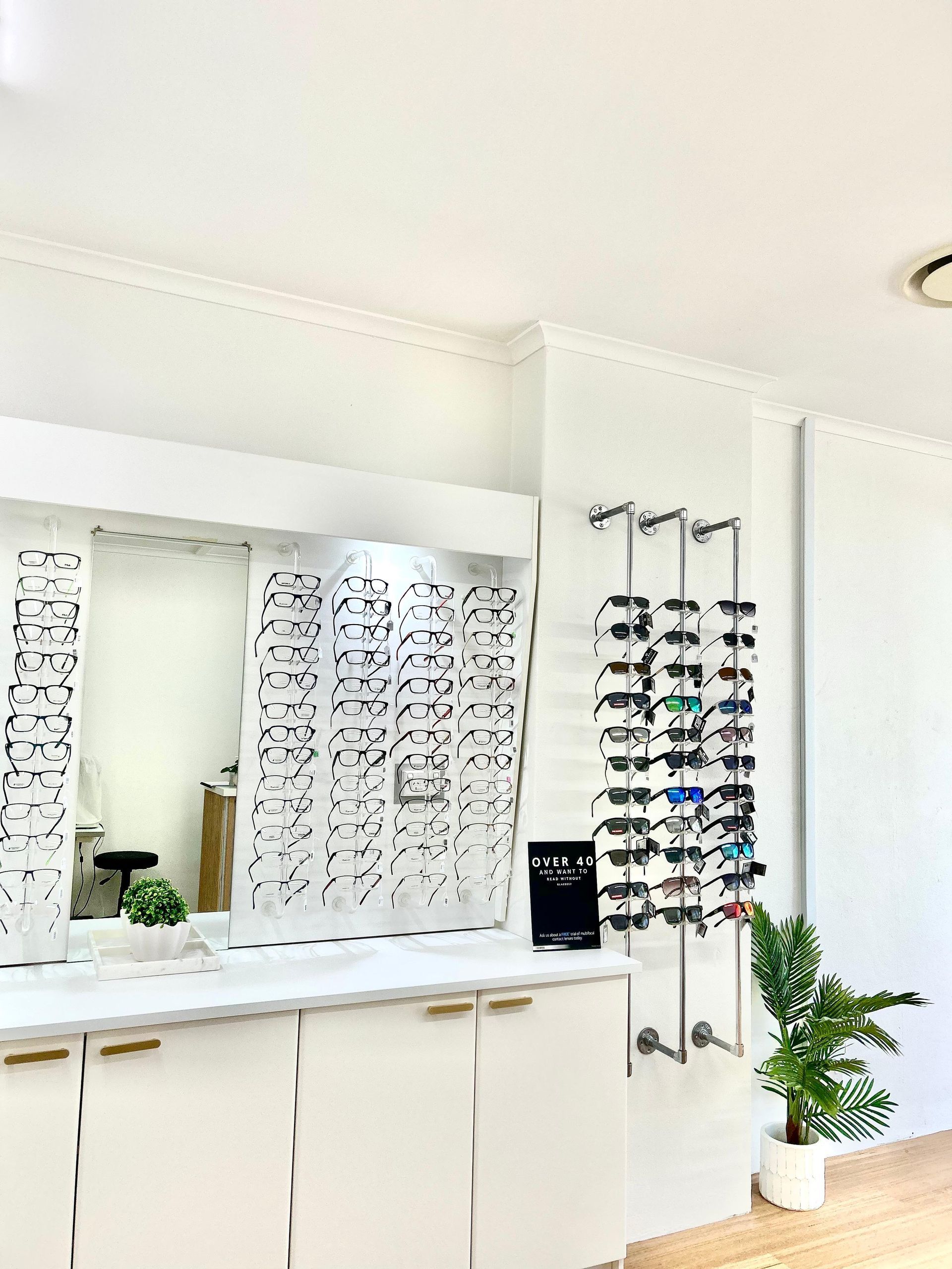 A Lot Of Sunglasses On The Wall In Optical Shop — Central Coast Eyecare In Budgewoi, NSW