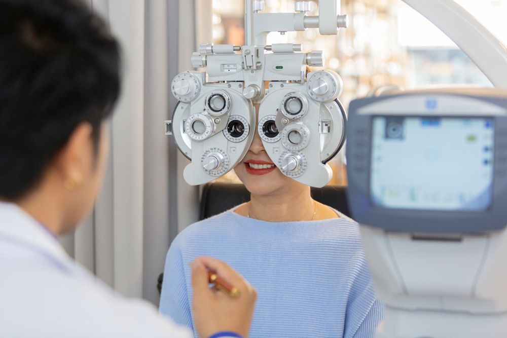 A Woman Is Getting Her Eyes Checked By An Ophthalmologist — Central Coast Eyecare In Gosford, NSW